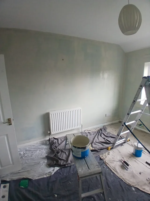 Interior decorating in progress, with floors protected.