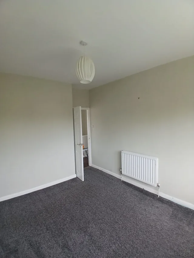 Finished pale walls and white woodwork in a decorated room